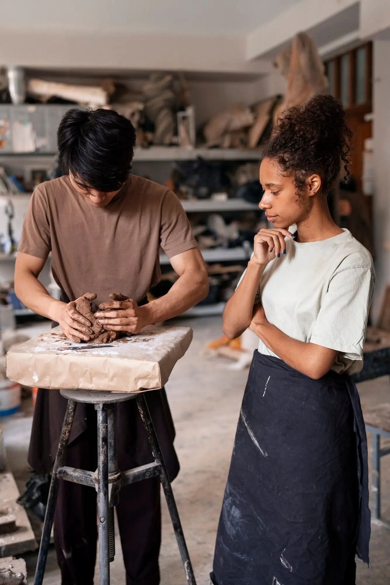 Menschen beim Modellieren mit Ton, halbnahe Einstellung.